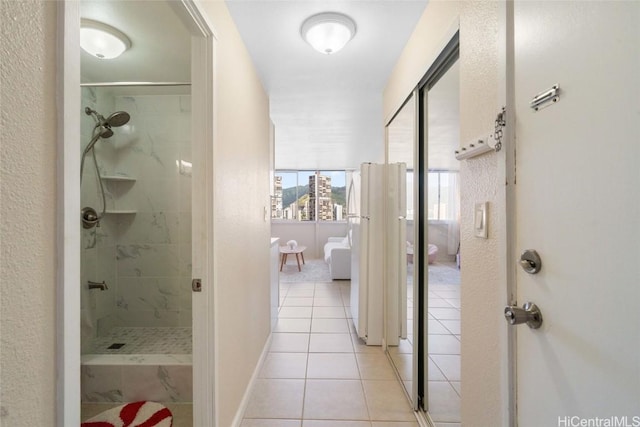 bathroom featuring tile patterned floors and tiled shower