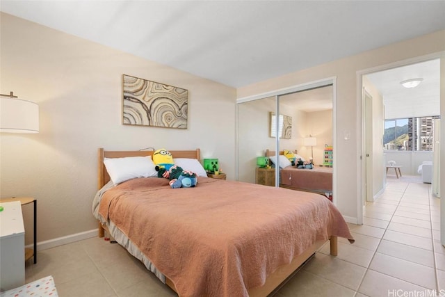 tiled bedroom featuring a closet