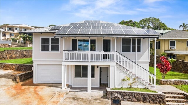 view of front of home featuring a garage and solar panels