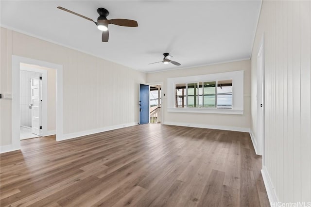 spare room with crown molding and wood-type flooring