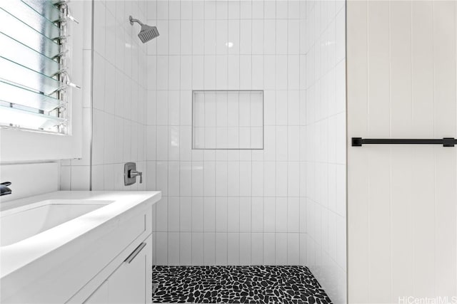 bathroom featuring sink and a tile shower