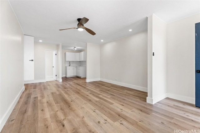 unfurnished living room featuring light hardwood / wood-style floors and ceiling fan