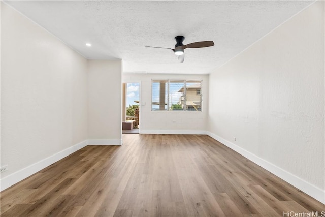 unfurnished living room with wood-type flooring, a textured ceiling, and ceiling fan