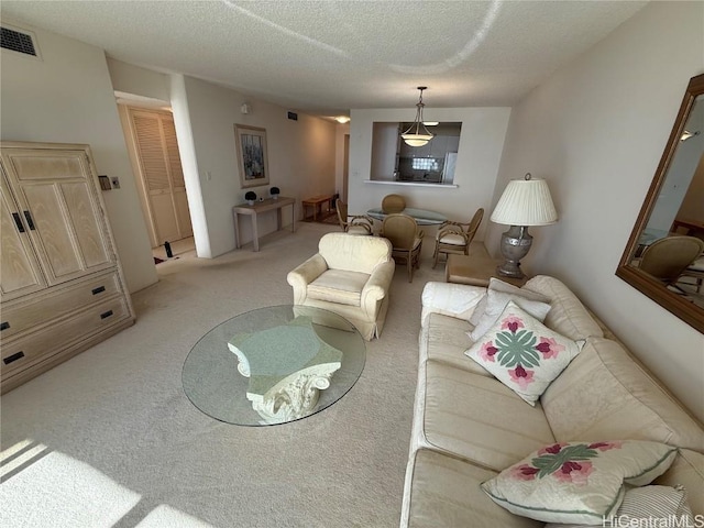 living room with light carpet and a textured ceiling