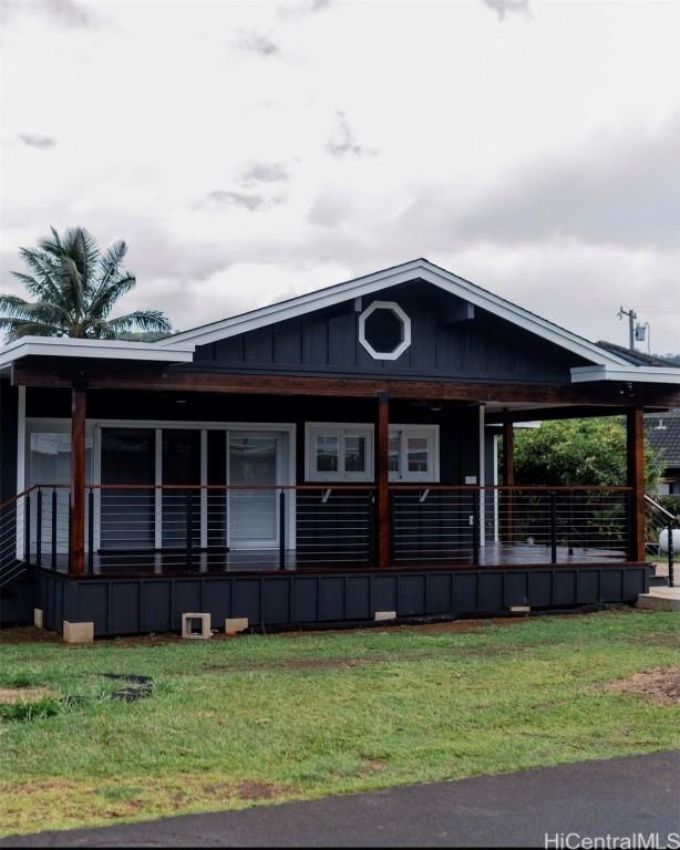 view of home's exterior featuring a yard and covered porch