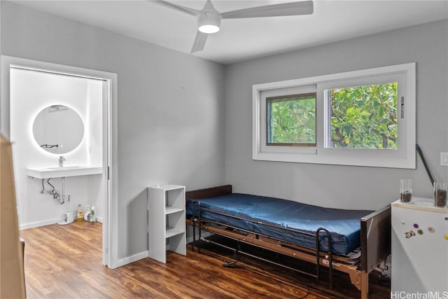 bedroom featuring a ceiling fan, wood finished floors, and baseboards