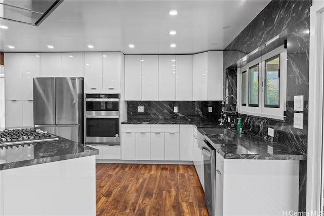 kitchen featuring white cabinetry, stainless steel appliances, dark wood-type flooring, and modern cabinets