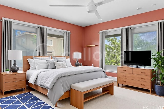 bedroom with a ceiling fan and wood finished floors