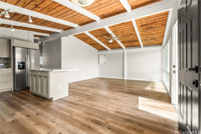 interior space featuring light hardwood / wood-style flooring, ceiling fan, track lighting, wooden ceiling, and beamed ceiling