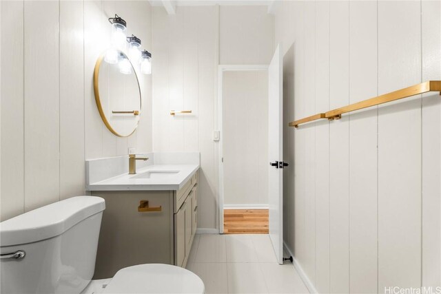 bathroom featuring toilet, vanity, and tile patterned flooring