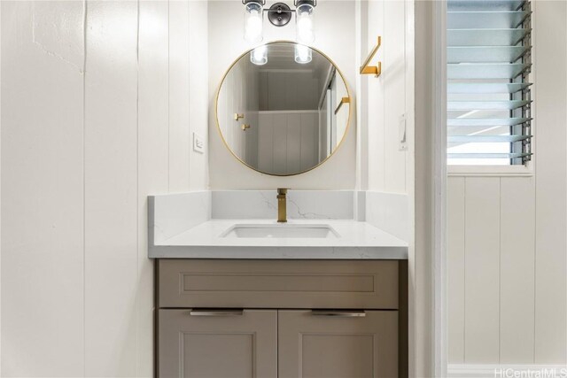 bathroom with vanity and wooden walls