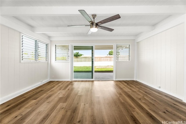 spare room with ceiling fan, beamed ceiling, and wood-type flooring