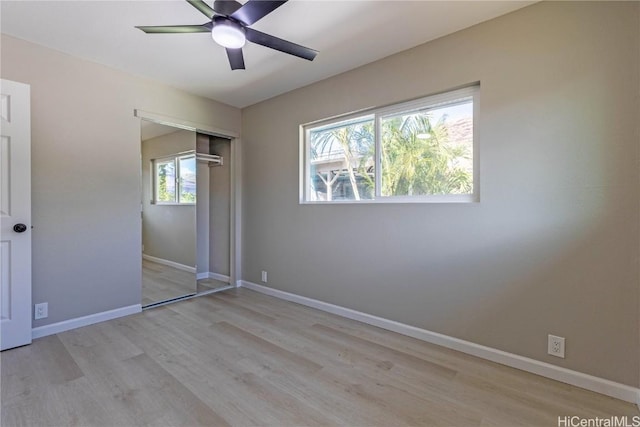 unfurnished bedroom featuring a closet, ceiling fan, and light hardwood / wood-style flooring