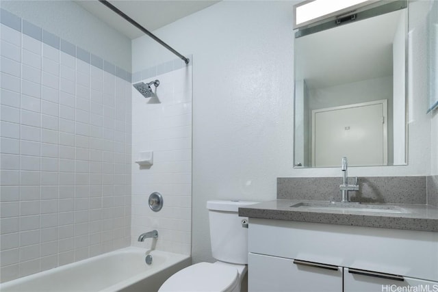 full bathroom featuring vanity, toilet, and tiled shower / bath combo