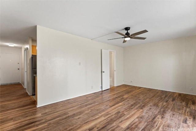 empty room featuring ceiling fan and dark hardwood / wood-style floors