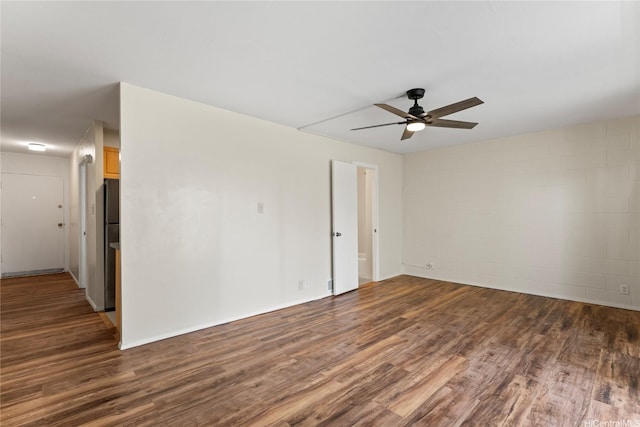 2875 S King St Unit 209, Honolulu, HI 96826 - spare room featuring wood finished floors, ceiling fan, and concrete block wall