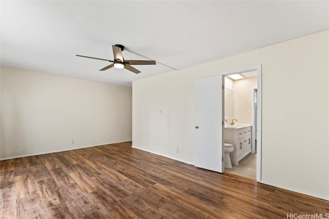 spare room with ceiling fan, wood-type flooring, and sink