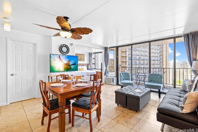 tiled dining space featuring ceiling fan and a wall of windows