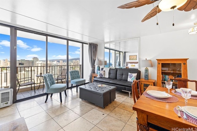 living room featuring tile patterned flooring, ceiling fan, and a healthy amount of sunlight