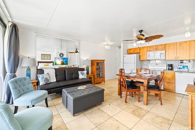 living room with ceiling fan and light tile patterned floors