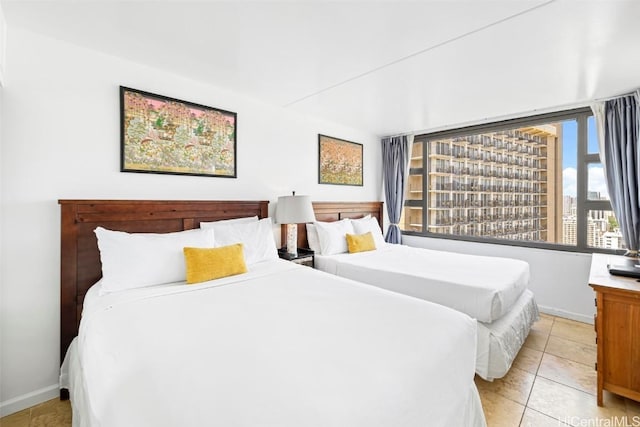 bedroom with light tile patterned floors