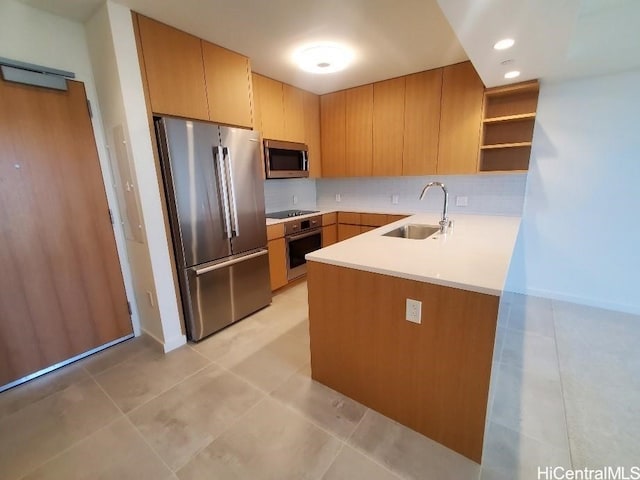 kitchen featuring sink, backsplash, light tile patterned floors, and appliances with stainless steel finishes