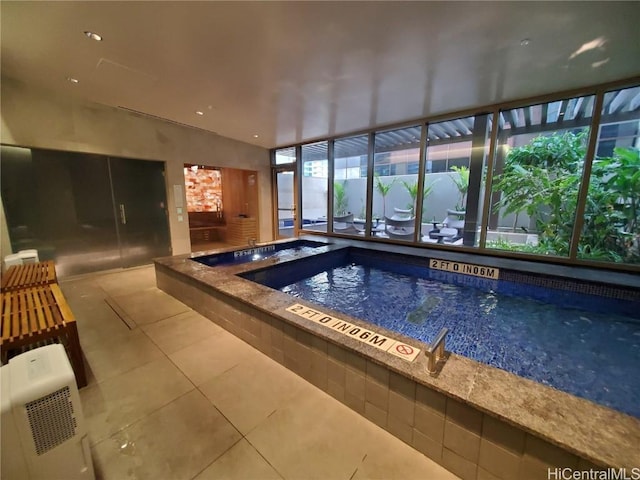 view of swimming pool with an indoor hot tub