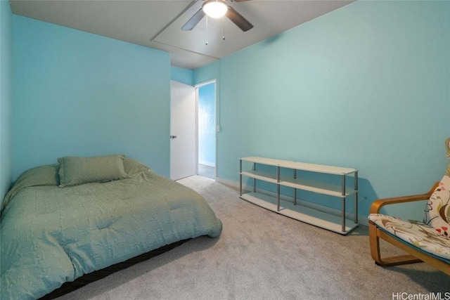 bedroom featuring ceiling fan and carpet