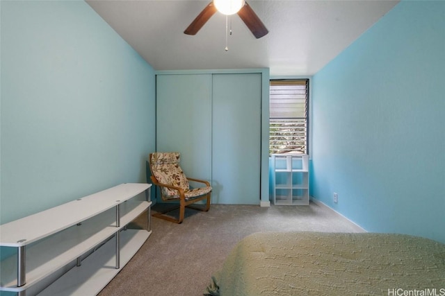 carpeted bedroom featuring ceiling fan and a closet