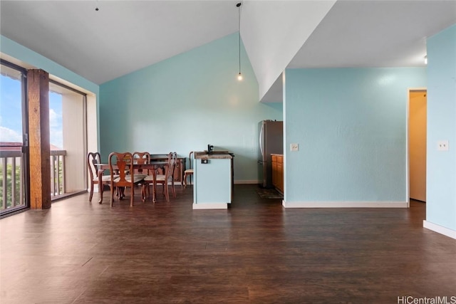 dining area featuring lofted ceiling and dark hardwood / wood-style flooring