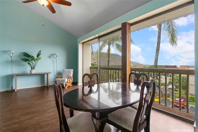 dining room with lofted ceiling, hardwood / wood-style flooring, and ceiling fan