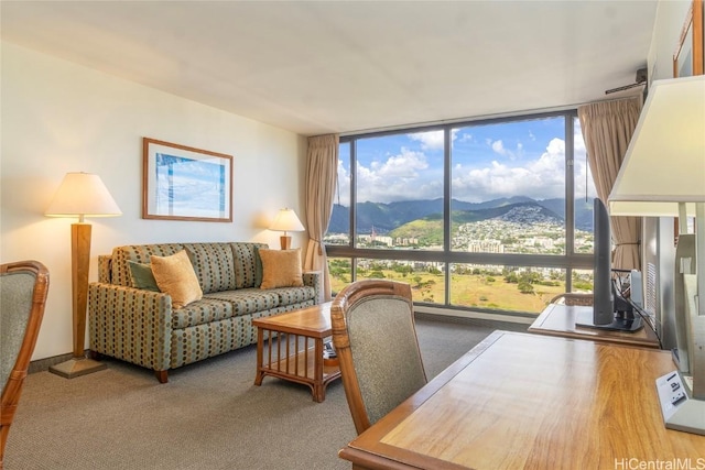 living room featuring expansive windows and carpet flooring