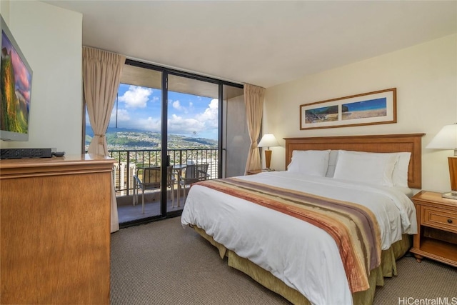 bedroom featuring access to outside, carpet, and a wall of windows