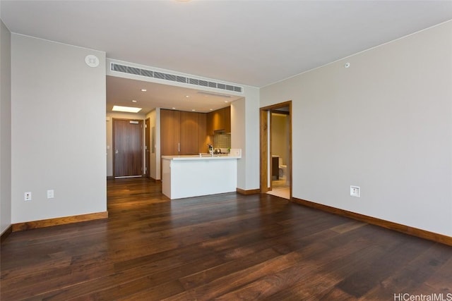 unfurnished living room with dark hardwood / wood-style floors