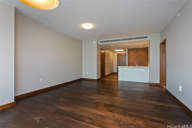 unfurnished living room featuring dark wood-type flooring