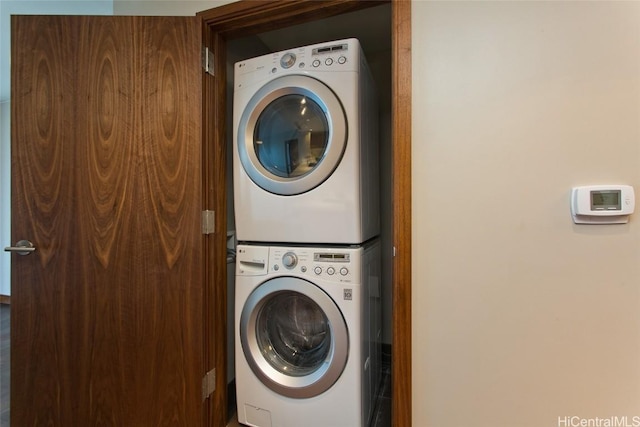 washroom featuring stacked washer / drying machine