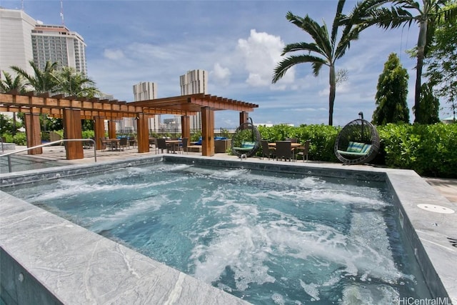 view of pool featuring a pergola and a hot tub