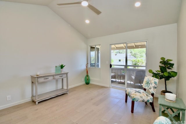 sitting room with light hardwood / wood-style flooring, vaulted ceiling, and ceiling fan