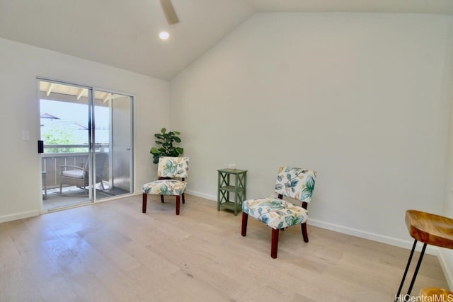 living area with ceiling fan, light wood-type flooring, and vaulted ceiling