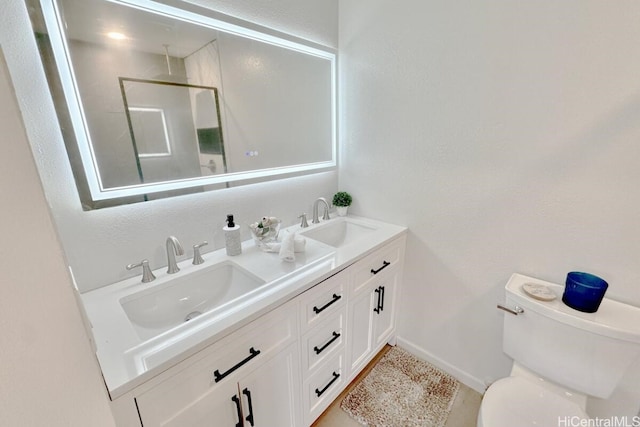 bathroom with walk in shower, vanity, and toilet