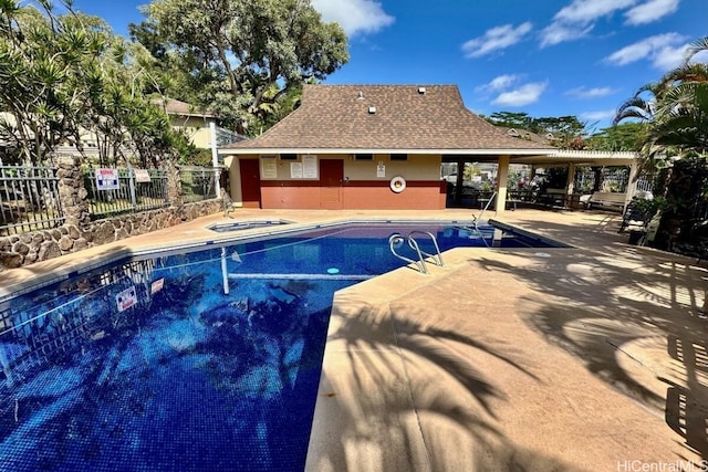 view of swimming pool featuring a community hot tub and a patio area