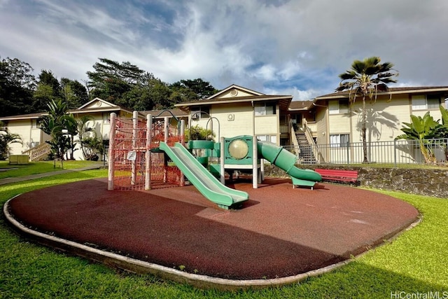 view of jungle gym featuring a lawn