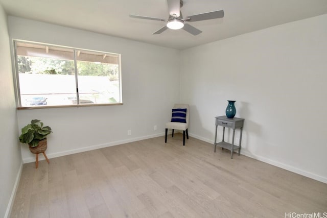 living area with ceiling fan and light hardwood / wood-style floors