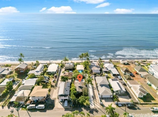 bird's eye view with a water view and a beach view