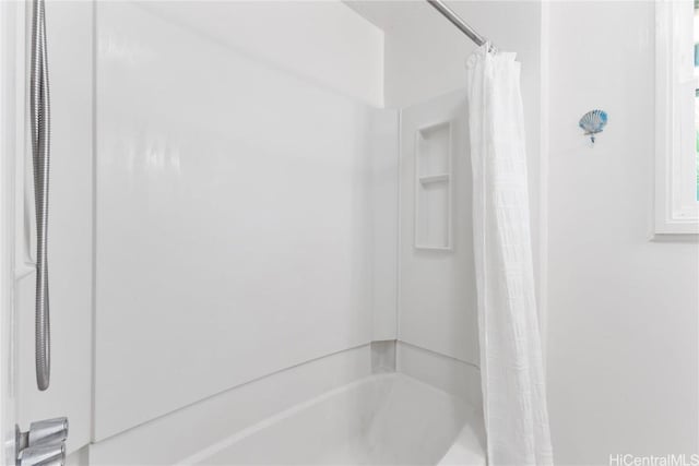 bathroom featuring shower / bathtub combination with curtain