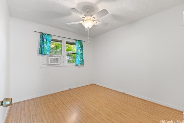 unfurnished room featuring ceiling fan, hardwood / wood-style floors, a textured ceiling, and cooling unit