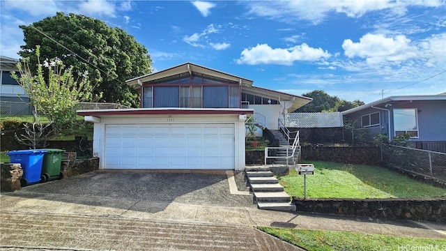 view of front of home featuring a garage and a front lawn