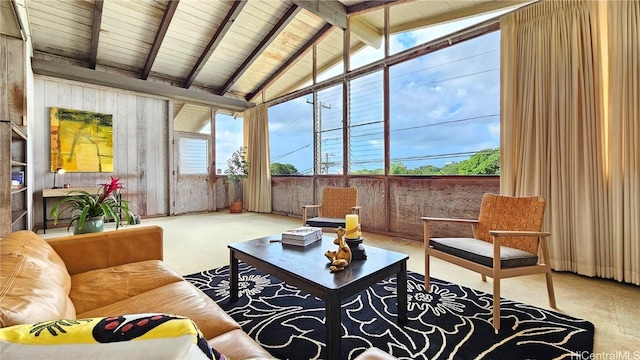 sunroom / solarium featuring lofted ceiling with beams