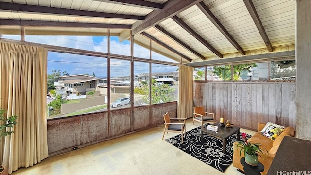 sunroom featuring vaulted ceiling with beams