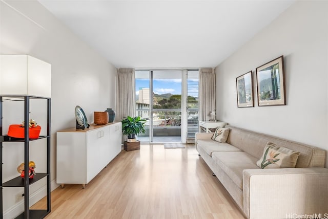 living room with expansive windows and light wood-style flooring